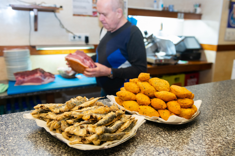 Fried sardines and cod fish cakes on display at Casa Louro, Porto, photo by Austin Bush